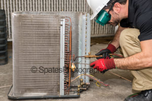 HVAC training brazing copper pipe on condensing unit