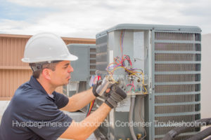 Dave Spates HVAC Technician removing wires from a run capacitor