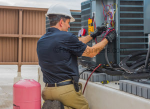 On the job hvac training, technician checking voltage at condensing unit