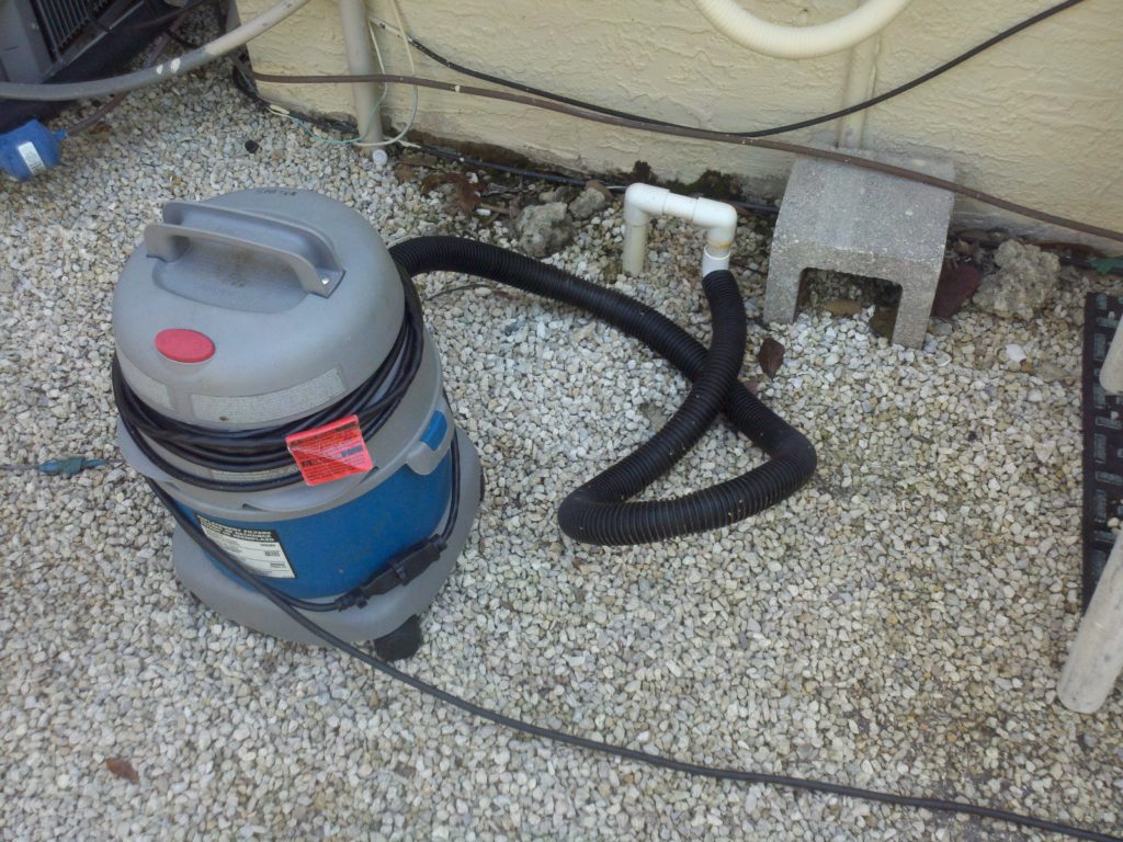 Cleaning a condensate drain line with a wet vacuum