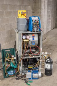 HVAC tools surrounding and old R22 water source heat pump