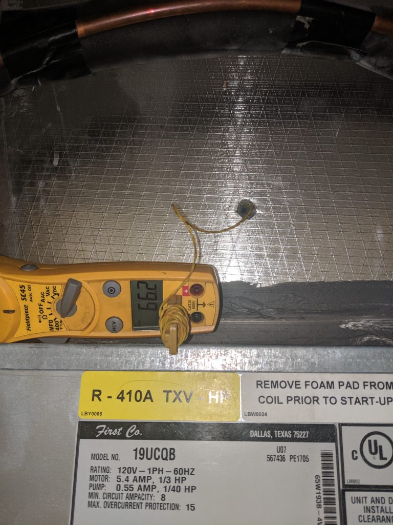 Fieldpiece multi meter with temperature probe at the supply side of a furnace / air handler showing the supply air temperature