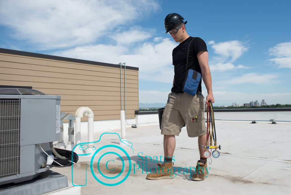 Hvac tech walking up on a rooftop condenser that has a frozen suction line