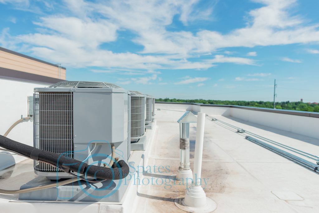 Air conditioning condensing units on a roof top of a building.