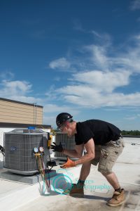 A highly upset, hvac technician yelling at a condenser and tools.